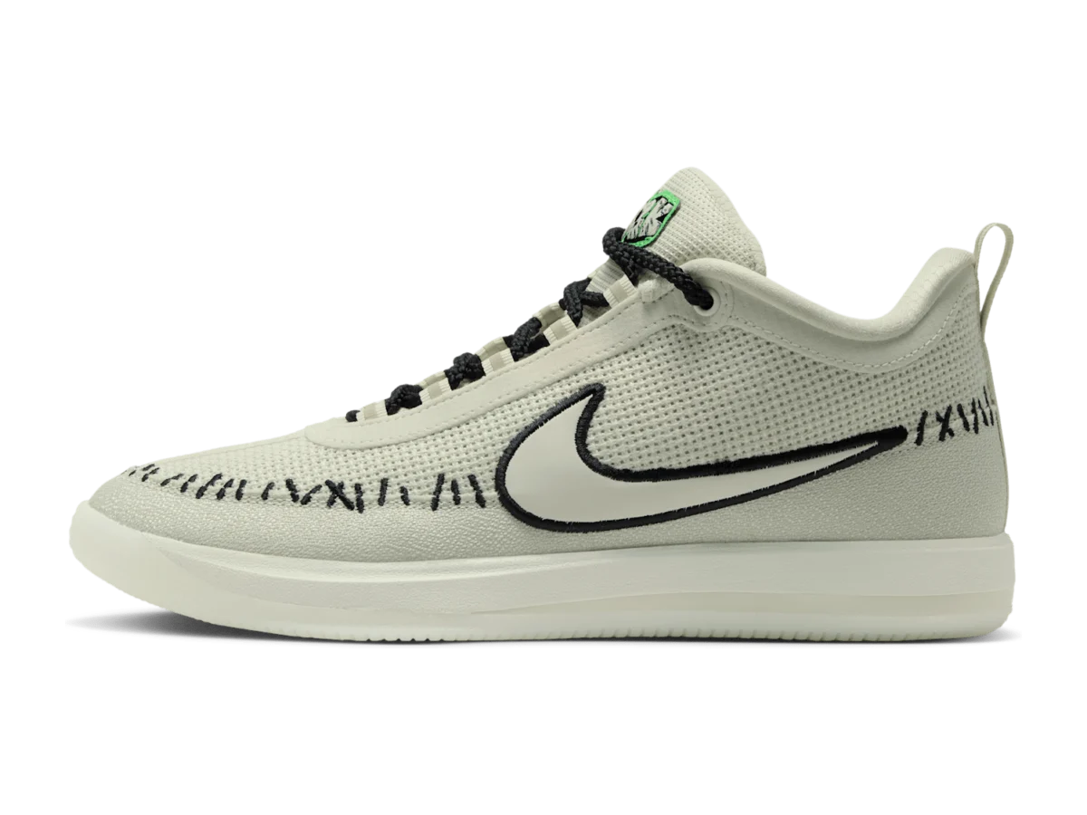 Nike Book 2 Scary Chapter, lateral side, pale grey-green mesh upper with a black-outlined Swoosh, black stitch marks and black rope laces